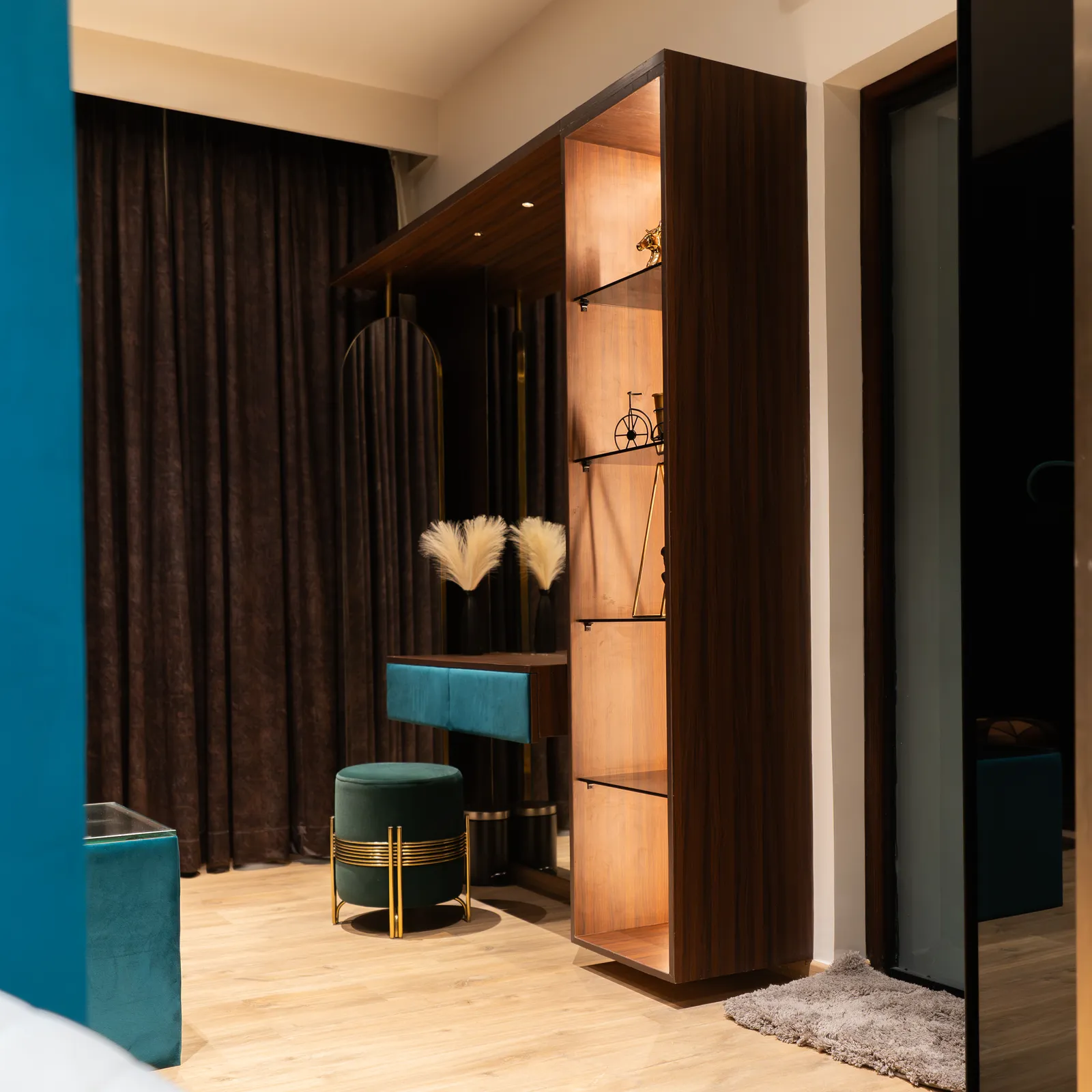 Dressing area with teal vanity, lit shelving and dark walnut joinery — Abhishek's Residence
